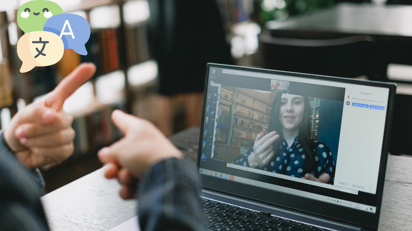 A person learning a new language through a video call, focused on the screen and actively engaging with their tutor.