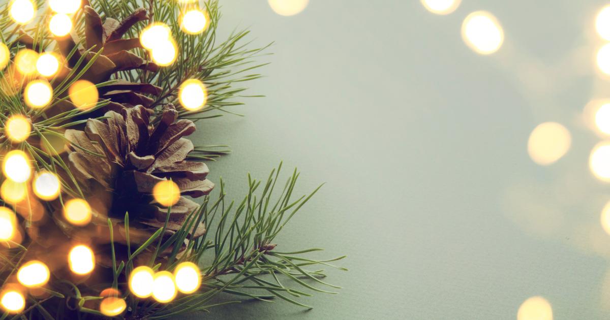 Close-up image of a Christmas tree with a light camera effect, highlighting twinkling lights and festive decorations.