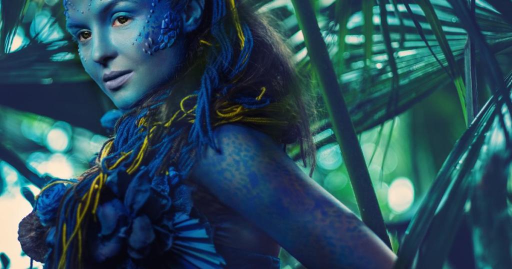 A depiction of a woman from Avatar 3, featuring blue skin, striking facial features, and intricate tribal patterns.