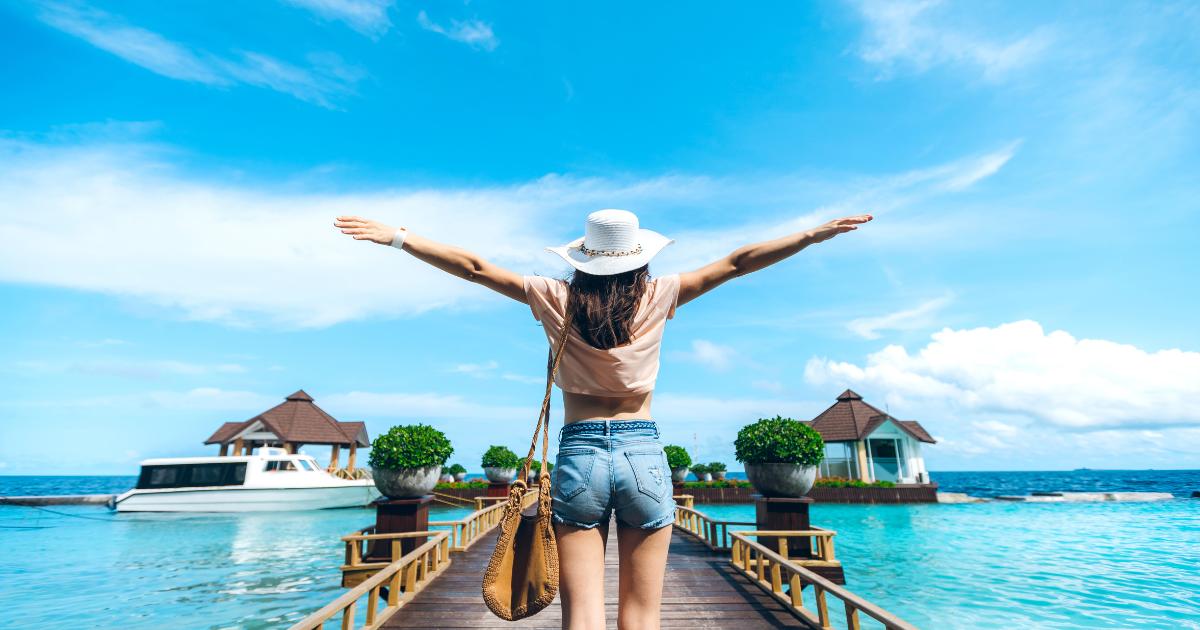 A woman on a tropical vacation in Bora Bora, enjoying the clear turquoise waters and stunning overwater bungalows.