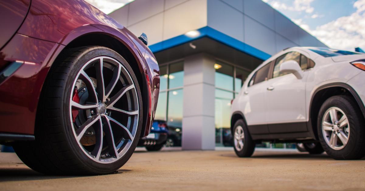 Close-up view of car wheels at a car dealership yard.