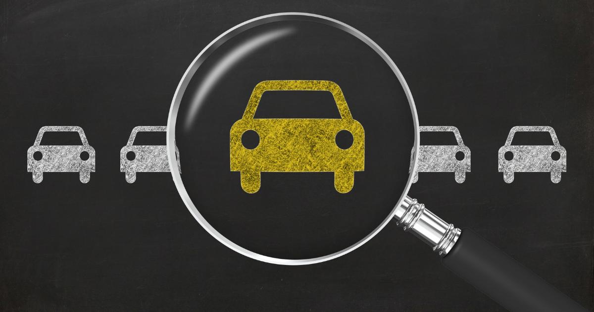 Illustration of five cars with a magnifying glass focusing on the middle yellow car.