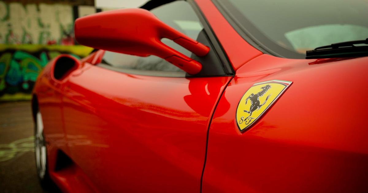 Close-up view of a red Ferrari new car, highlighting its sleek curves and iconic design features.