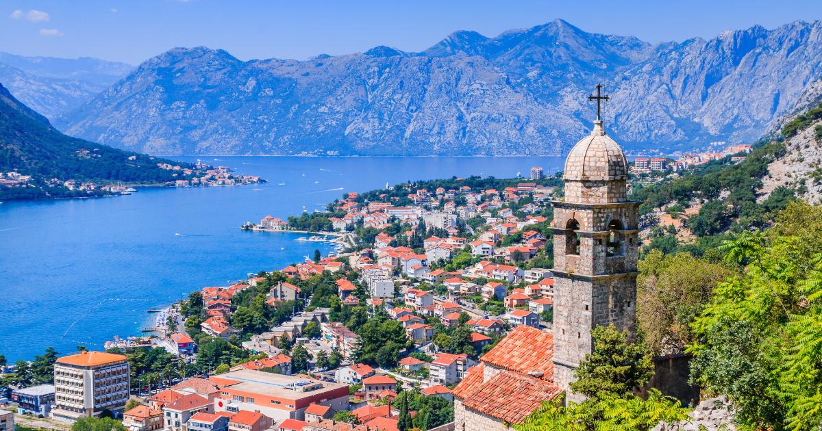 A stunning view of Kotor, Montenegro, hidden gems featuring a historic town, picturesque bay, and surrounding mountain landscapes.